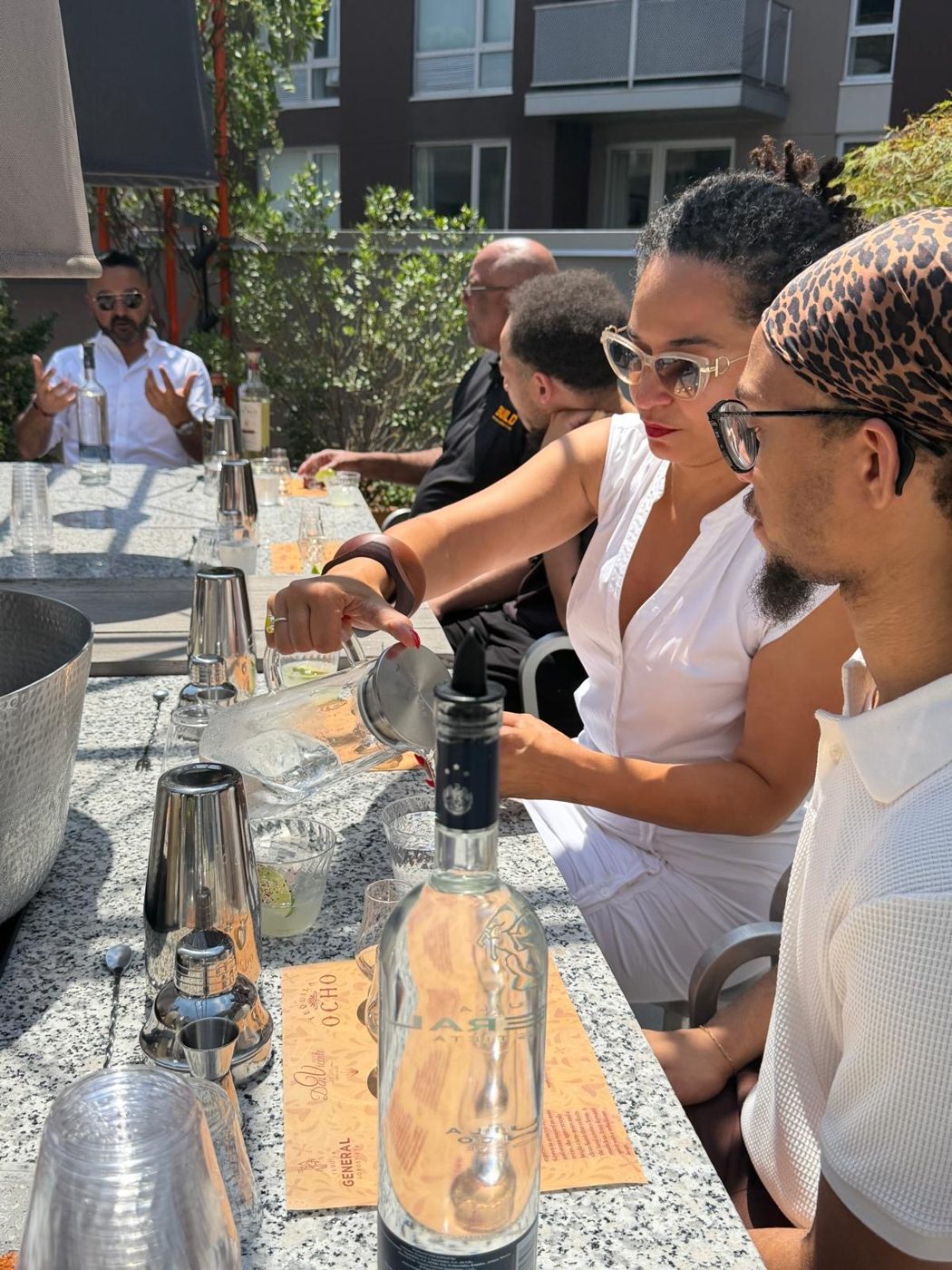 Guests mixing agave cocktails at an outdoor tasting