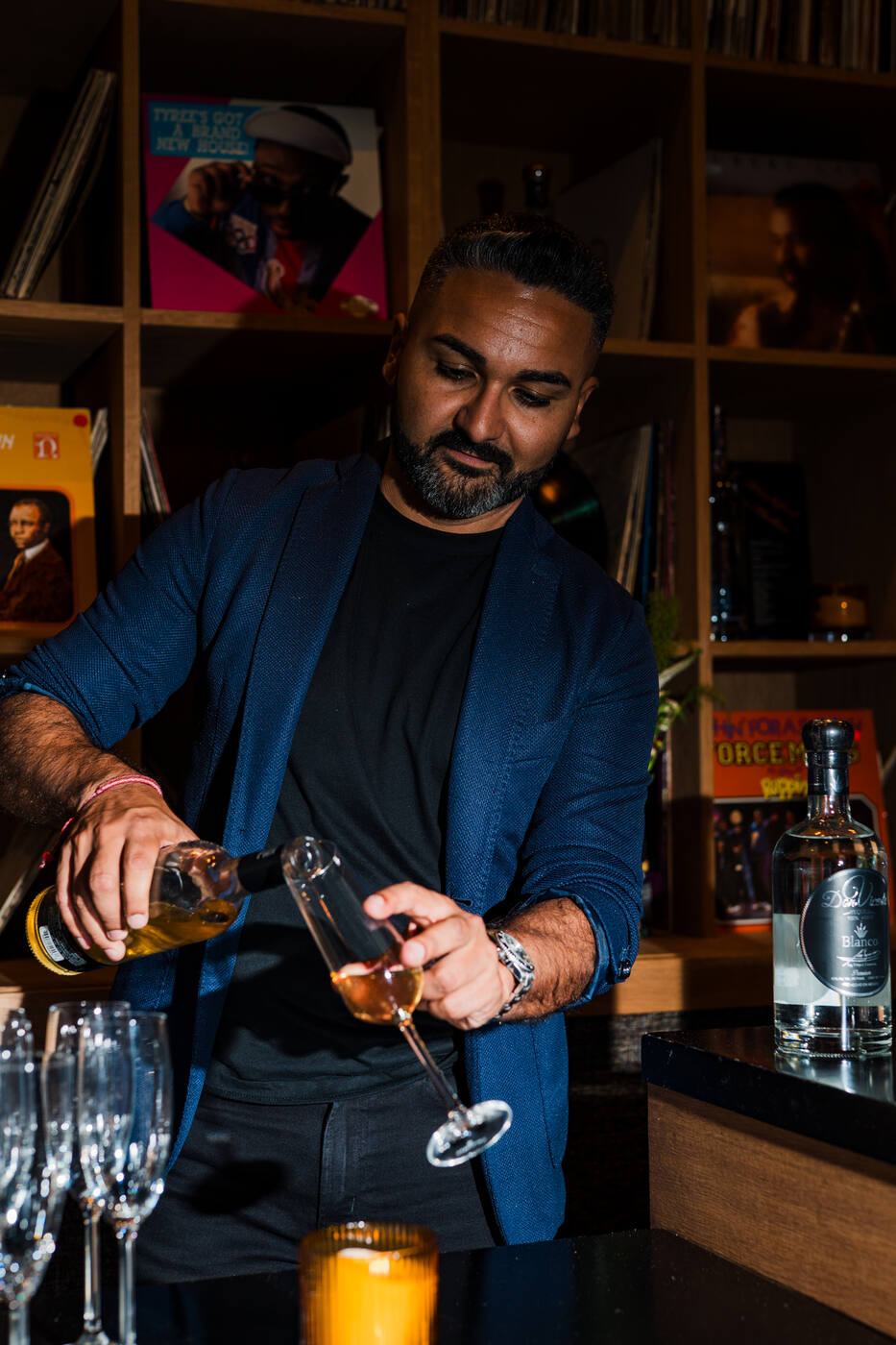 Randy Serrano pouring a tasting flight behind the bar